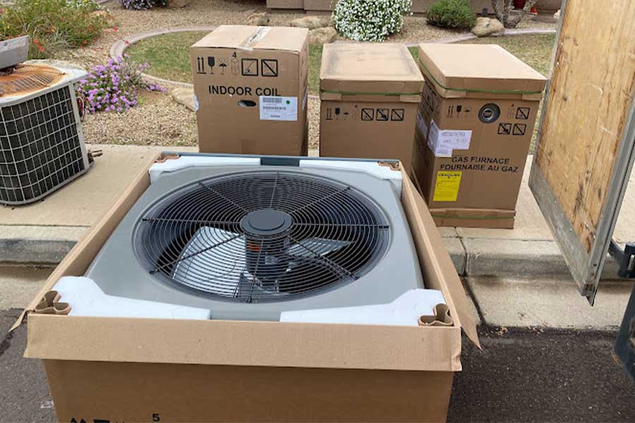 New HVAC equipment in boxes ready for installation at a residential site