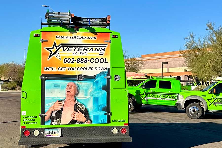 Back of a bright green Veterans AC PHX service van with cooling ad