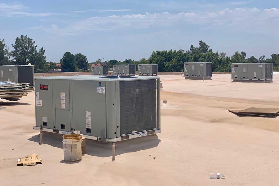 Multiple commercial HVAC units installed on a flat rooftop