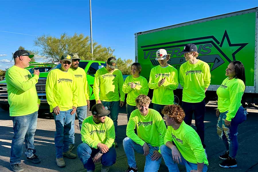 Veterans AC PHX team gathered outdoors in matching neon shirts