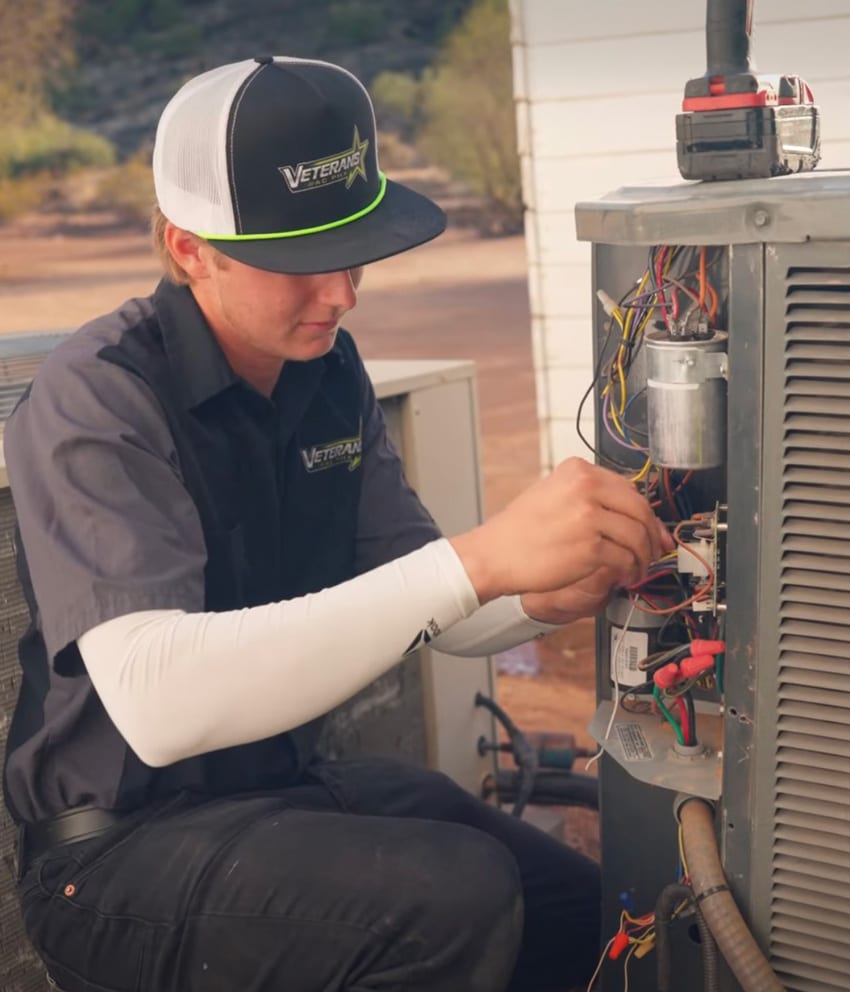 HVAC technician working on an AC unit
