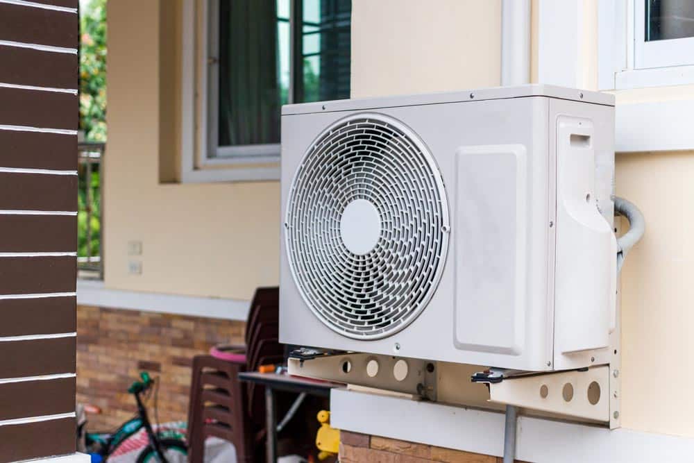 Wall-mounted outdoor AC unit installed on a residential building