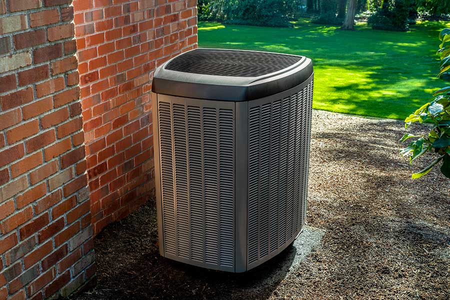 Outdoor air conditioner by a brick wall